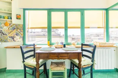 a dining room table with two chairs and a window at Rome Top floor with Terrace in Rome