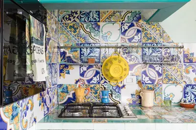 a kitchen with a wall covered in colorful tiles at Rome Top floor with Terrace in Rome