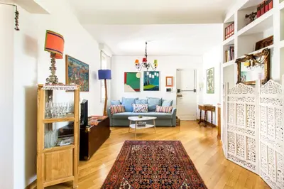 a living room with a blue couch and a rug at Rome Top floor with Terrace in Rome