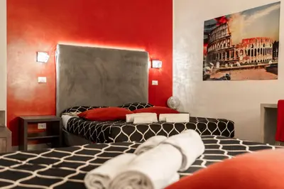a bedroom with two beds and a painting on the wall at Le Terrazze di San Giovanni in Rome