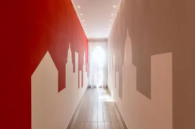 a hallway with red and white walls and a window at Le Terrazze di San Giovanni in Rome