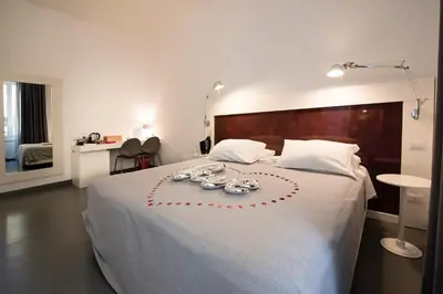 a bedroom with a bed with a heart drawn on it at Inn Urbe Colosseo in Rome