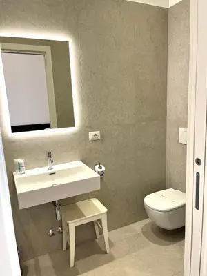 a bathroom with a sink and a toilet and a mirror at Inn Urbe Colosseo in Rome