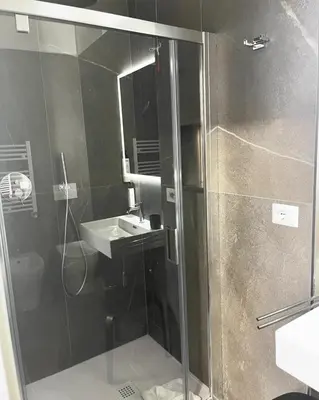 a bathroom with a shower and a sink at Inn Urbe Colosseo in Rome