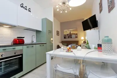 a kitchen with a table and chairs in it at Vaticano terrace: brand new 2 bedrooms 2 bathrooms in Rome