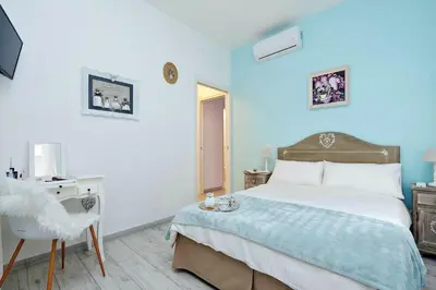 a blue bedroom with a bed and a chair at Vaticano terrace: brand new 2 bedrooms 2 bathrooms in Rome