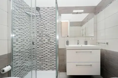 a bathroom with a shower and a sink and a toilet at Vaticano terrace: brand new 2 bedrooms 2 bathrooms in Rome