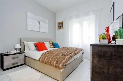 a bedroom with a bed and a dresser at Vaticano terrace: brand new 2 bedrooms 2 bathrooms in Rome