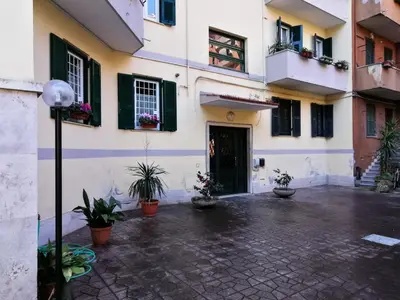 a courtyard of a building with potted plants at GARBATELLA'S in ROME in Rome