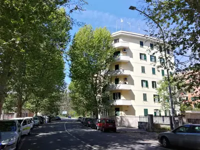 a white building on the side of a street at GARBATELLA'S in ROME in Rome