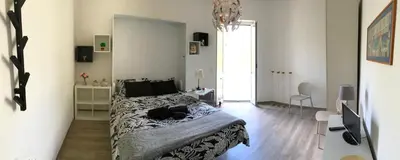 a dog laying on a bed in a bedroom at GARBATELLA'S in ROME in Rome