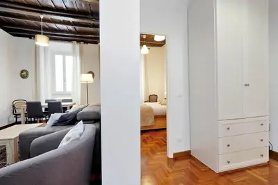 a living room with a couch and a bedroom at Pellegrino in Rome