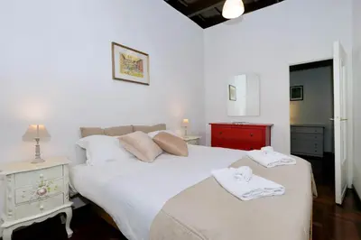 a bedroom with a large white bed with towels on it at Pellegrino in Rome