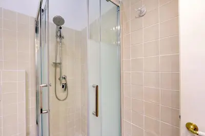 a shower with a glass door in a bathroom at Pellegrino in Rome