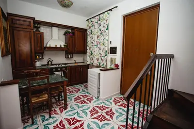 a kitchen with a table and a refrigerator in it at Delfini Trevi House in Rome