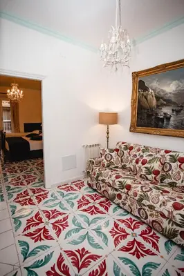 a living room with a couch and a rug at Delfini Trevi House in Rome