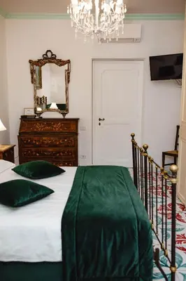 a bedroom with a bed with a mirror and a dresser at Delfini Trevi House in Rome