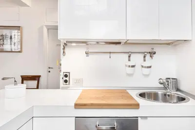 a kitchen with white cabinets and a sink at Campo de' Fiori Apartment in Rome