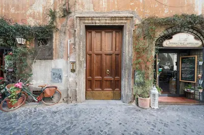 a bike parked in front of a building with a door at Campo de' Fiori Apartment in Rome