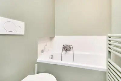 a bathroom with a white tub and a toilet at Campo de' Fiori Apartment in Rome