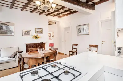 a kitchen and living room with a table and a stove at Campo de' Fiori Apartment in Rome