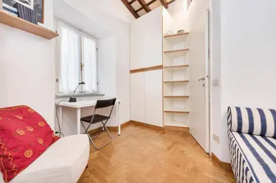 a white room with a desk and a chair at Campo de' Fiori Apartment in Rome