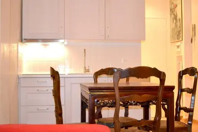 a kitchen with a wooden table and two chairs at Central quiet apartment and terrace in Rome