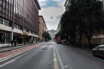 an empty street in a city with buildings at Casa Linnea in Rome