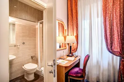 a bathroom with a desk and a toilet and a sink at Hotel San Valentino in Rome