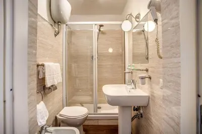 a bathroom with a toilet and a sink and a shower at Hotel San Valentino in Rome