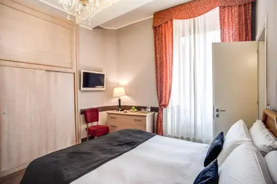 a hotel room with a bed and a desk at Hotel San Valentino in Rome