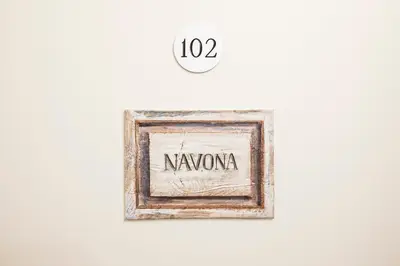 a picture frame with the word navonia on a wall at Trastevere Gallery Suites in Rome