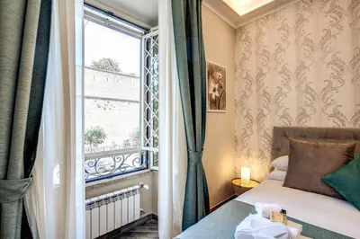 a bedroom with a bed and a window at Dimore Vespasiano in Rome