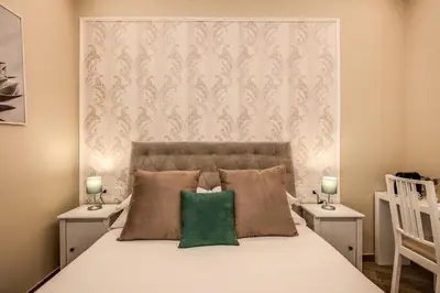 a bedroom with a large bed with two night stands at Dimore Vespasiano in Rome