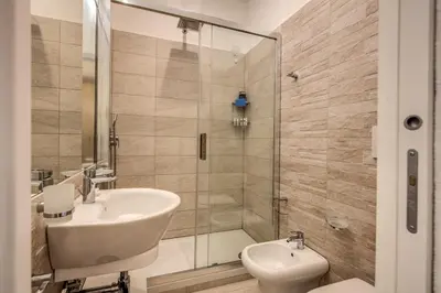 a bathroom with a shower and a sink and a toilet at Dimore Vespasiano in Rome