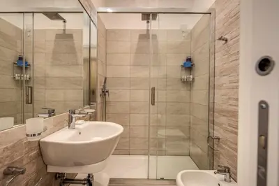 a bathroom with a sink and a shower at Dimore Vespasiano in Rome