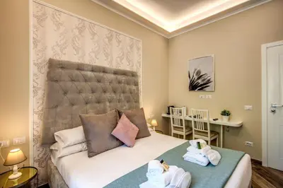 a bedroom with a bed with towels on it at Dimore Vespasiano in Rome