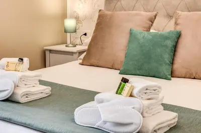 a bed with towels and pillows on it at Dimore Vespasiano in Rome