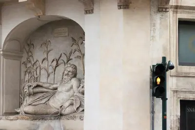 a statue on the side of a building with a traffic light at Trevi Grand Blu Suite B&B in Rome