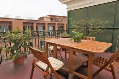 a wooden table and chairs on a balcony at Trevi Grand Blu Suite B&B in Rome