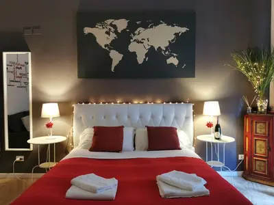 a bedroom with a large bed with a world map on the wall at 109 SUITES ROMA in Rome
