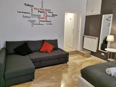 a living room with a couch and a heart on the wall at 109 SUITES ROMA in Rome