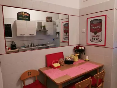 a miniature kitchen with a table and a counter top at 109 SUITES ROMA in Rome