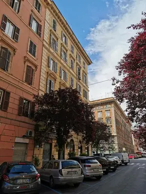 a row of cars parked in front of buildings at 109 SUITES ROMA in Rome