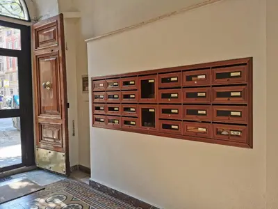 a wooden chest of drawers on a wall at 109 SUITES ROMA in Rome