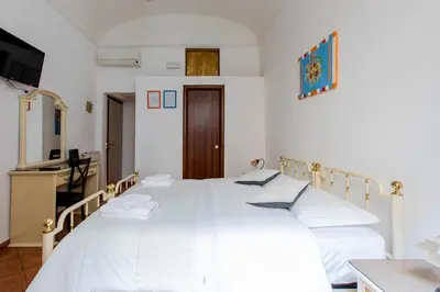 a bedroom with two beds with white sheets at Oscar 3 in Rome