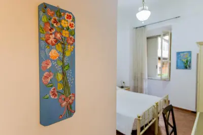a painting of flowers on the wall of a bedroom at Oscar 3 in Rome