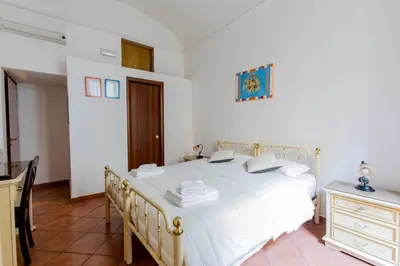 a white bedroom with a white bed and a dresser at Oscar 3 in Rome