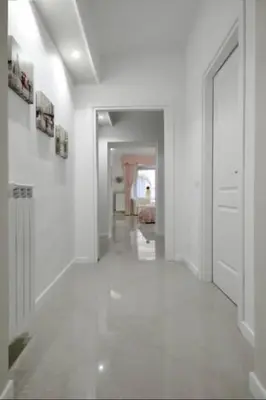 a hallway with white walls and white floors and a room at Ludovisi Barberini Grand Apartment in Rome