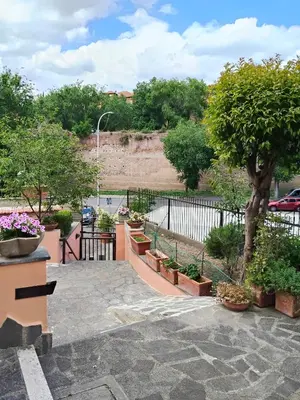 a garden with potted plants and a fence at Appartament Piramide Cestia in Rome